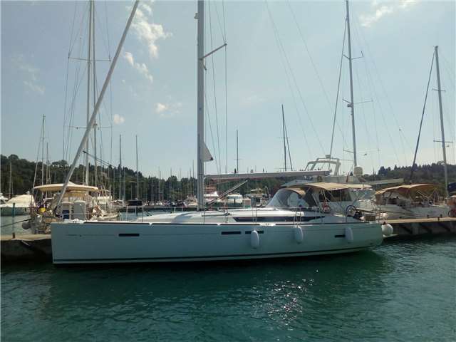 Jeanneau Sun Odyssey 449 2018 anchored in a serene marina, showcasing elegant lines and spacious deck.